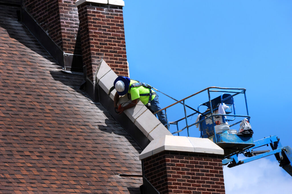 Workers in safety gear on a church roof